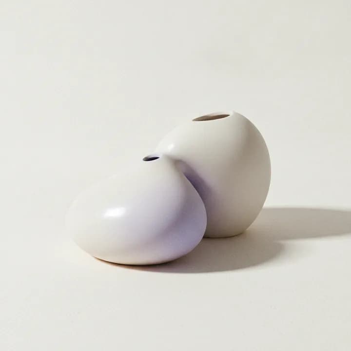 Abstract illustration: two pale forms set down beside each other, their shadows overlapping