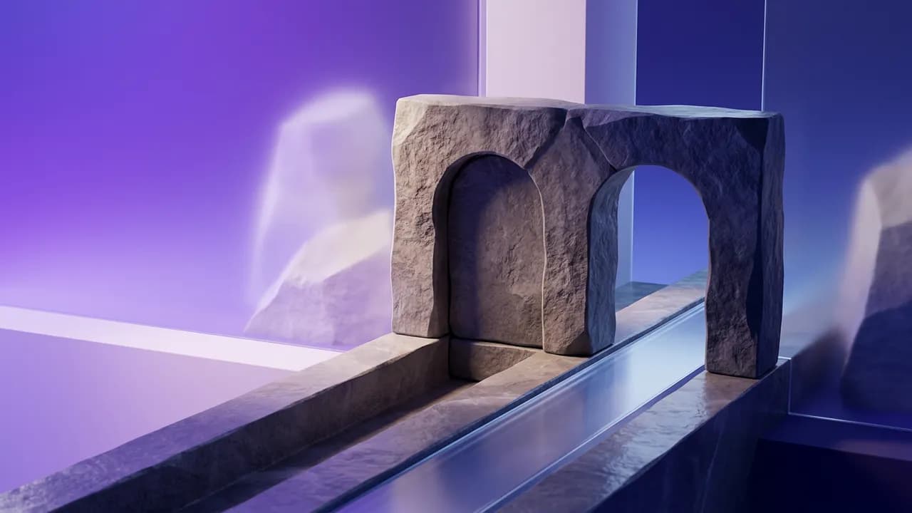 A grey stone double arch stands over a narrow channel of water in a purple-lit room.